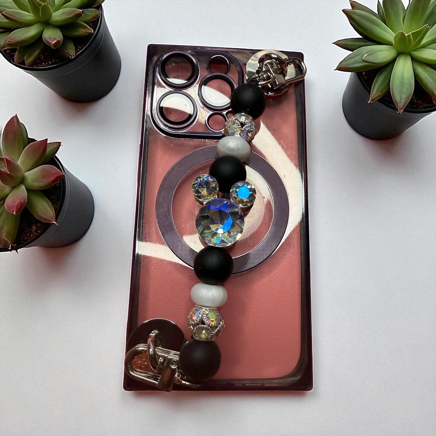 Phone charm chains with adhesive backing